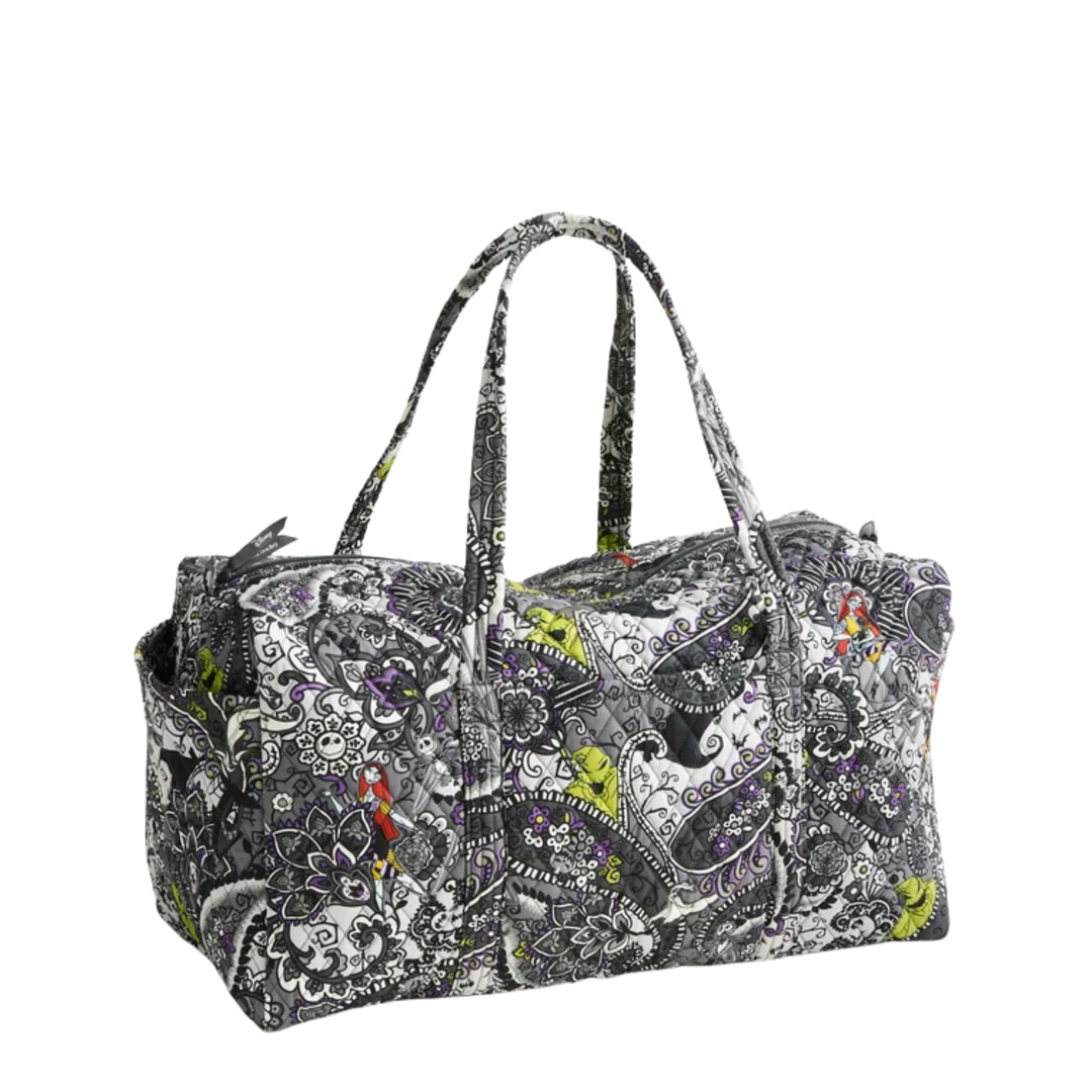 A duffel bag with a complex paisley and floral pattern in black, white, gray, and small accents of green, red, and purple, featuring dual top handles, shown on a plain white background.