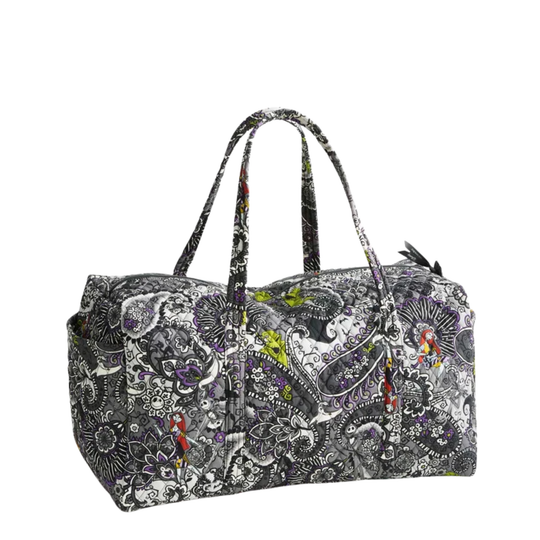 A duffel bag with a black, white, and gray paisley and floral pattern, featuring small colorful accents in purple, red, and green, shown on a plain white background.