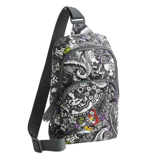 A single-strap sling backpack with a black, gray, and white paisley pattern and small colorful accents, shown on a plain white background.