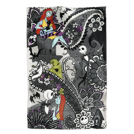 A rectangular textile product, likely a towel or blanket, featuring a detailed Day of the Dead inspired illustration of Jack Skellington and Sally. The design is primarily black and white with intricate floral and paisley patterns, accented by Sally's bright red hair and blue skin, and other small character details.