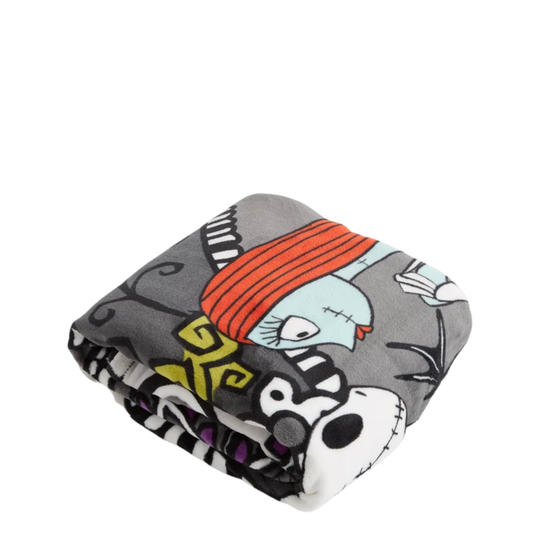 A folded gray blanket featuring a cartoon character print with orange hair, a stitched face, and black-and-white striped details, shown on a plain white background.