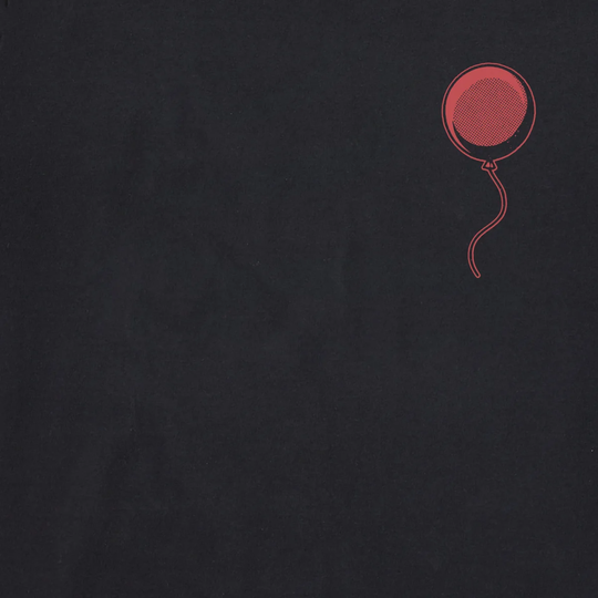 A close-up of a dark charcoal gray fabric with a small red balloon graphic printed in the upper right corner.
