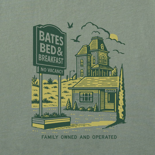 A graphic print on a muted sage green fabric background, featuring a vintage-style illustration of Bates Bed & Breakfast with a 'No Vacancy' sign, a haunted house, birds, and the text 'Family Owned and Operated'.