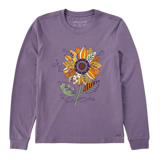 A purple long-sleeve crewneck shirt featuring a colorful, patterned sunflower graphic on the front, displayed against a solid white background.