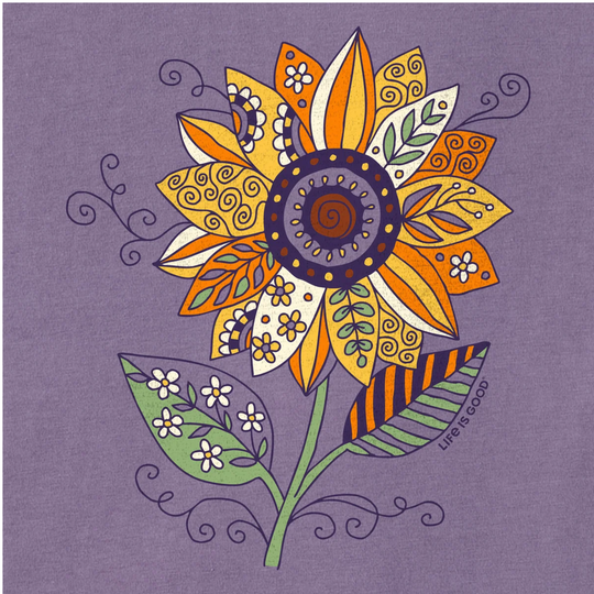 A stylized decorative sunflower illustration on a lavender-purple background. The flower has orange, yellow, cream, green, and purple patterned petals, with green leaves and stems.