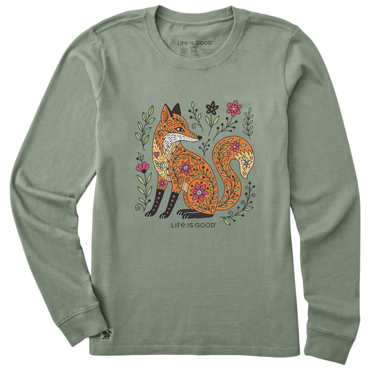 A sage green long-sleeve crewneck t-shirt featuring a colorful graphic of a patterned fox surrounded by flowers, with 'LIFE IS GOOD' printed below the graphic.