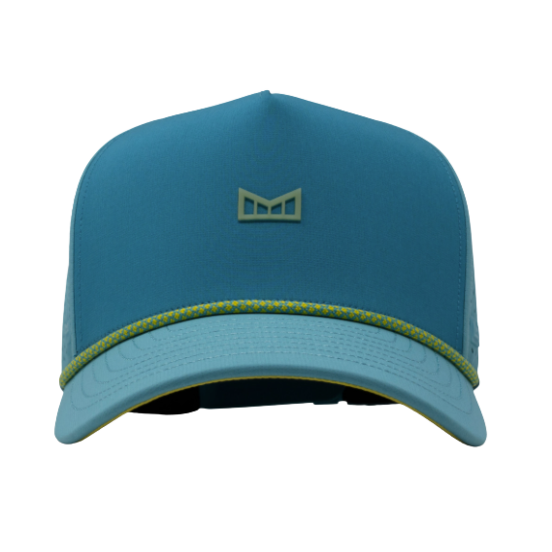 A structured baseball cap in a medium teal blue color, featuring a small geometric logo on the front panel and a thin yellow-green stitched trim along the edge of the brim.