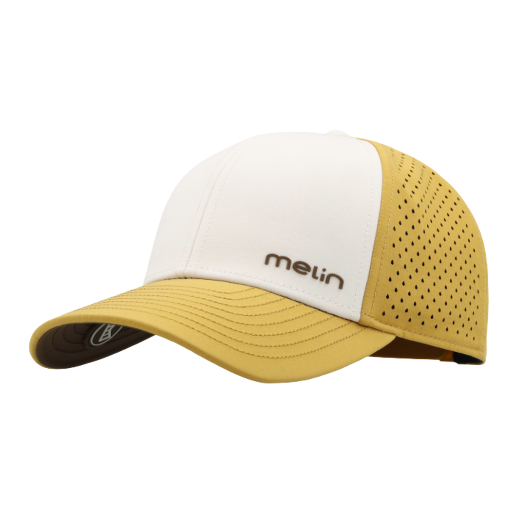 A Melin brand trucker-style baseball cap with a white front panel and a mustard yellow brim and perforated mesh back panels, shown on a plain white background.