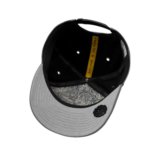A black and gray snapback cap shown from a top-down angle, featuring a black crown, a light gray brim, a black embroidered logo on the side, and a yellow interior label.
