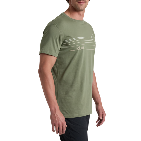 A man wearing a sage green athletic t-shirt with a white horizontal stripe graphic and the word 'KILIL' printed on the chest, shown from a side profile against a white background.
