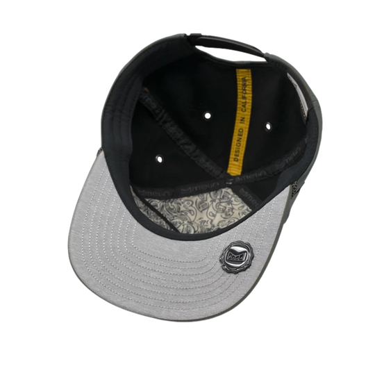 A structured snapback cap shown from a top-down angle on a white background. The cap features a light gray brim with a black embroidered logo, a black mesh back, and a black fabric crown with a yellow interior label.