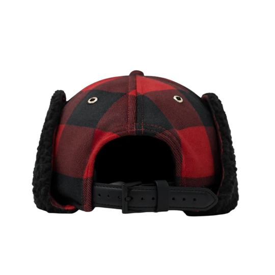 A red and black buffalo plaid winter trapper hat with black fleece ear flaps , shown against a plain white background.