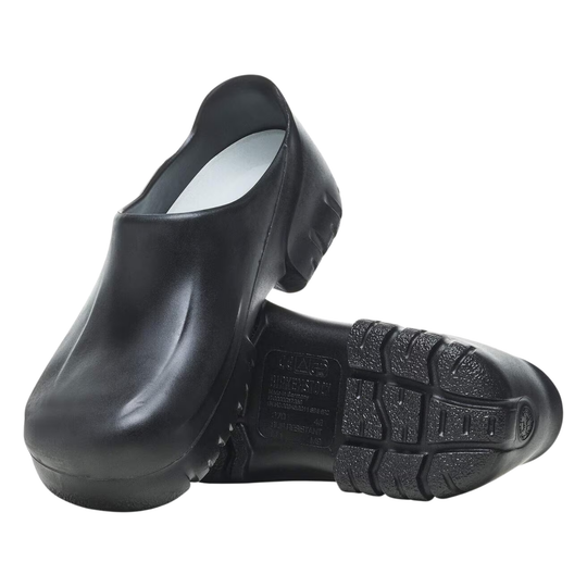A pair of black rubber safety shoes shown on a white background, with one shoe standing upright and the other lying on its side to display the treaded sole.