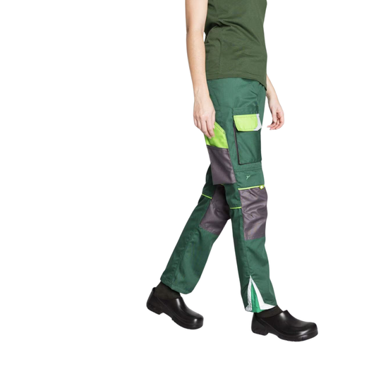 A person wearing green and gray work pants with high pockets and bright neon green accents, paired with a dark green shirt and black shoes, shown against a plain white background.