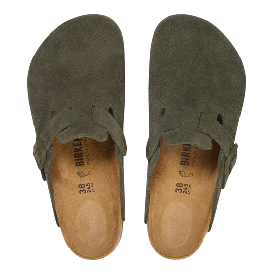 pair of olive green clogs with a suede-like finish, featuring a single adjustable strap with a buckle closure, a cork-look midsole, and a solid green outsole, shown against a plain white background.