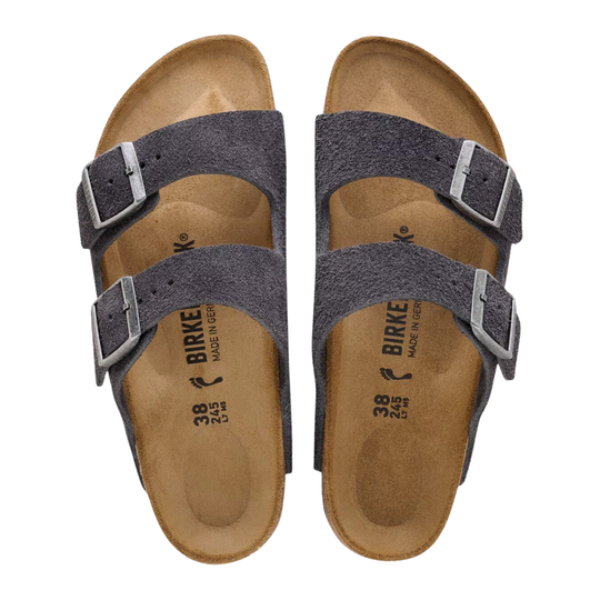 A pair of Birkenstock Arizona slide sandals in dark gray suede with adjustable silver buckles and a tan footbed, shown from a top-down view on a white background.