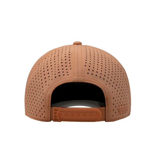 A structured baseball cap in a warm tan or peachy-brown color, featuring perforated panels on the front and side, a matching curved brim, and a small embossed logo on the side.
