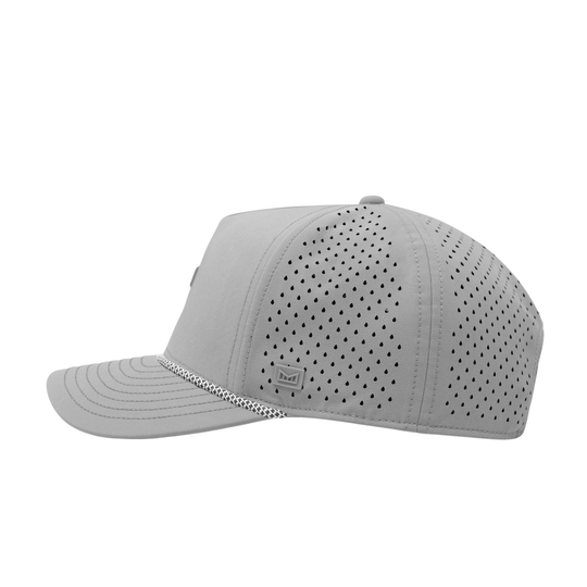 The side view of a light gray perforated baseball cap with an adjustable strap and a small 'melin' brand logo on the side.