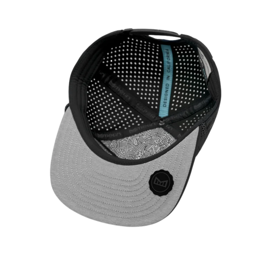 Top-down view of a baseball cap showing a light gray brim, black mesh back panels, and a light blue interior label that reads 'designed in california'.