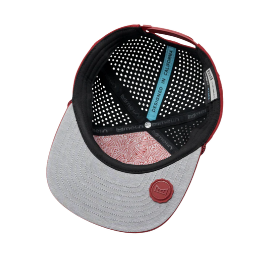 A structured baseball cap shown from a top-down angle, featuring a light gray brim with a red circular logo, black mesh back panels, and red trim.