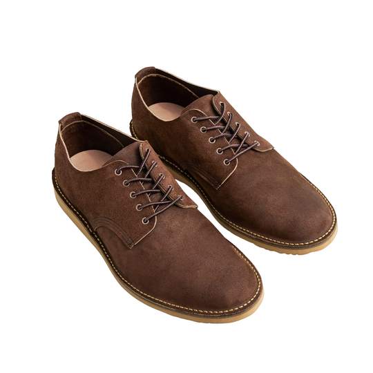 A pair of men's brown suede lace-up shoes with contrast stitching and tan soles, photographed on a clean white background.