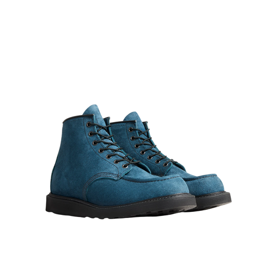 A pair of blue suede lace-up boots with a black sole, shown in a side profile on a solid white background.