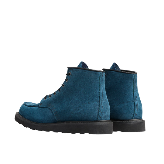 A pair of blue suede lace-up boots with a black sole, shown in a back profile on a solid white background.