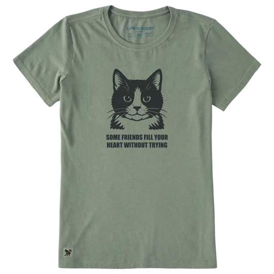 An olive green short-sleeve t-shirt with a black graphic of a cat's face and the text 'SOME FRIENDS FILL YOUR HEART WITHOUT TRYING' printed on the chest.