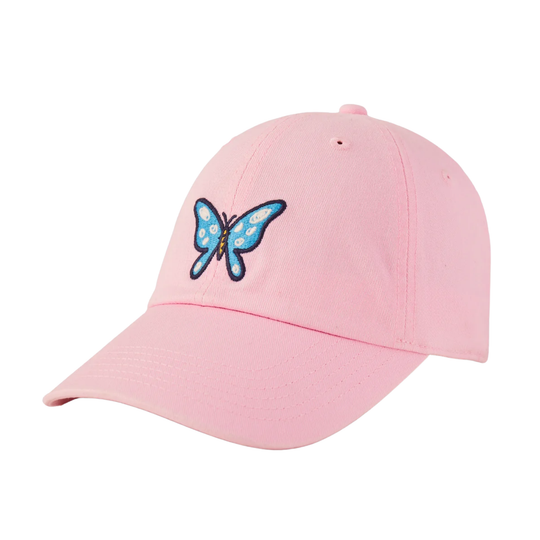 A light pink baseball cap featuring an embroidered blue butterfly with white spots and black outlines on the front, set against a plain white background.