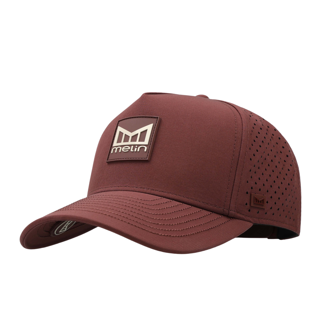 A chestnut Melin baseball cap with a structured crown, perforated side panels, and a brown rectangular logo patch on the front.