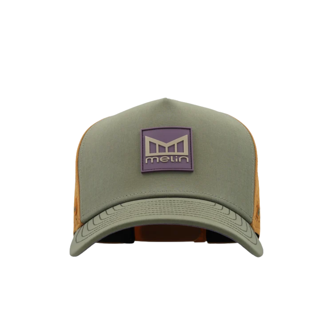 An olive green trucker hat with orange mesh side panels and a purple front patch featuring the Melin brand logo.