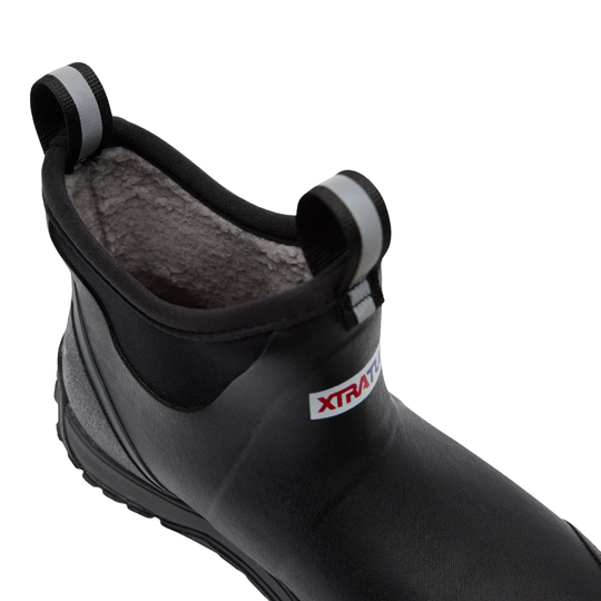 A close-up of a black rubber boot with a gray fleece lining and a small white XTRA brand tag on the side, set against a plain white background.