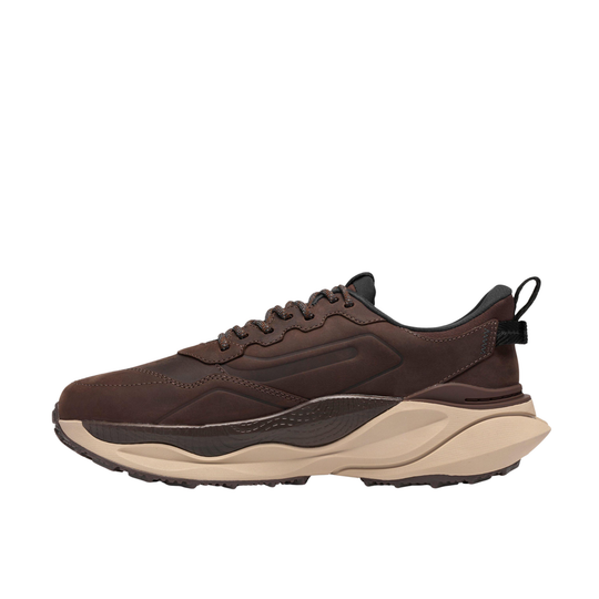A dark brown athletic sneaker with a chunky beige and dark brown midsole, shown in a side profile on a solid white background.