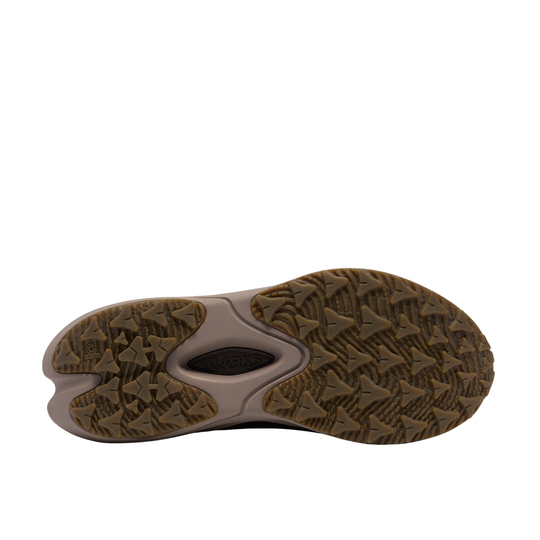 A close-up, top-down view of a shoe's textured brown outsole, showing the tread pattern and a central black logo embossed with 'MWS'.
