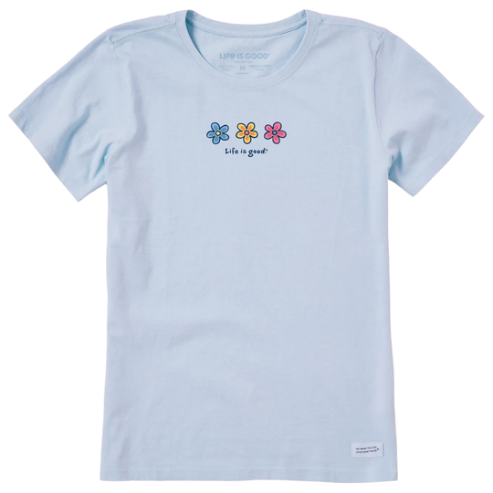 A light blue short-sleeve crewneck t-shirt by Life is GOOD, featuring three small colorful flowers (blue, yellow, pink) and the text 'life is good?' printed on the chest.
