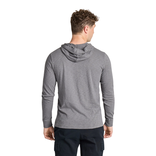 A man viewed from the back wearing a heather gray long-sleeve hooded shirt and dark cargo pants, against a plain white background.