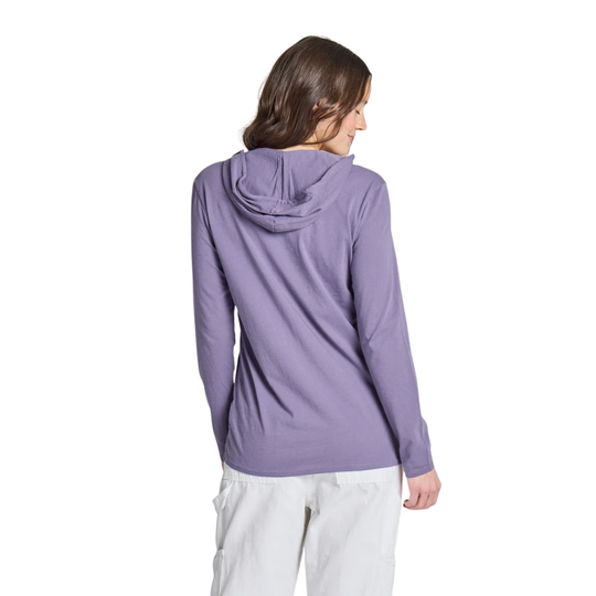 A woman shown from the back wearing a lavender-purple hooded long-sleeve top and white pants against a plain white background.