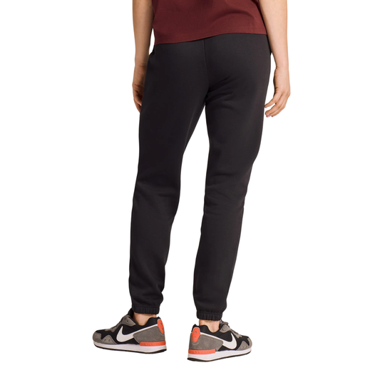 A person shown from the back wearing black jogger-style pants, a burgundy top, and gray Nike sneakers against a plain white studio background.