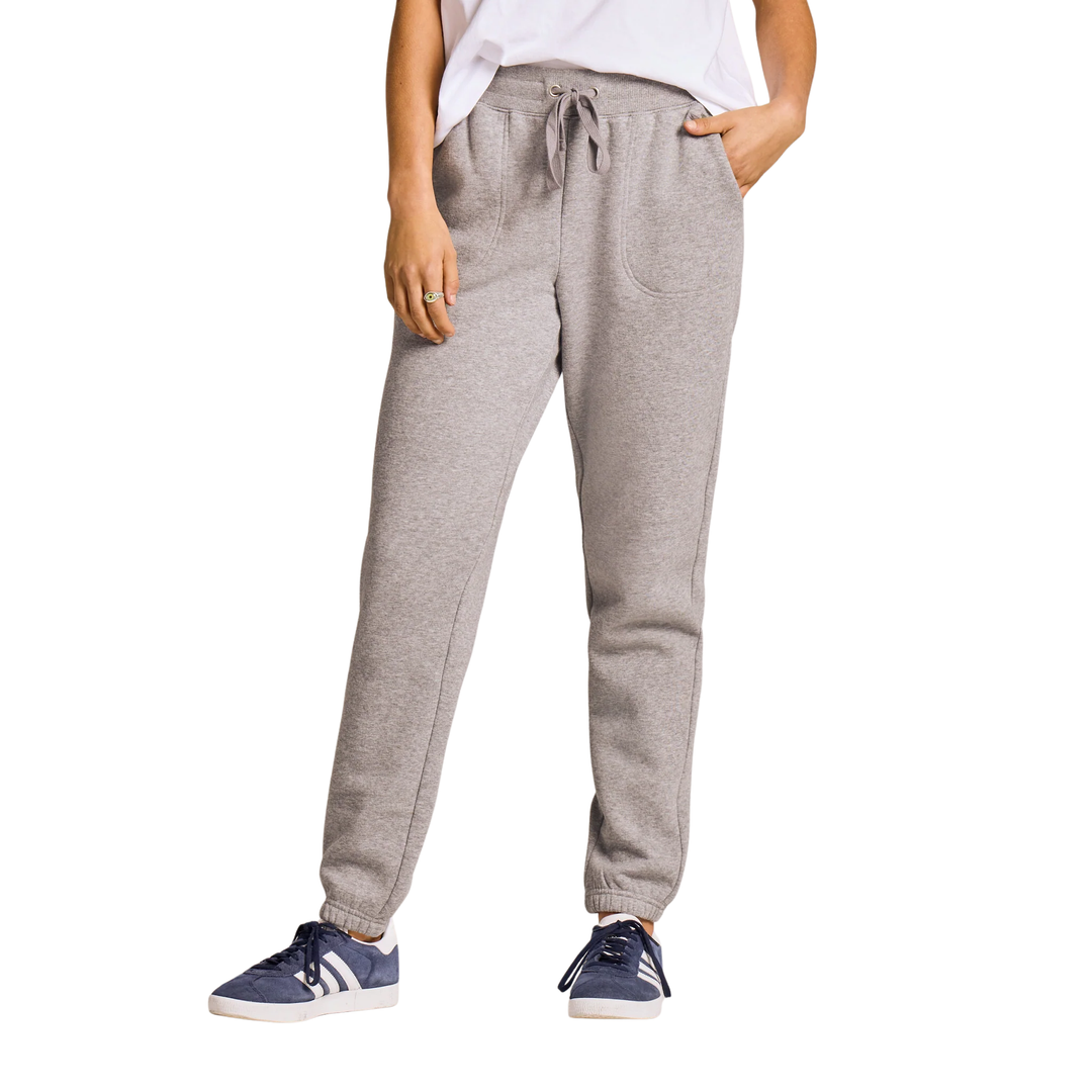A person wearing heather gray jogger sweatpants with a drawstring waist, side pockets, and elastic cuffs, paired with a white top and navy sneakers, shown against a plain white background.