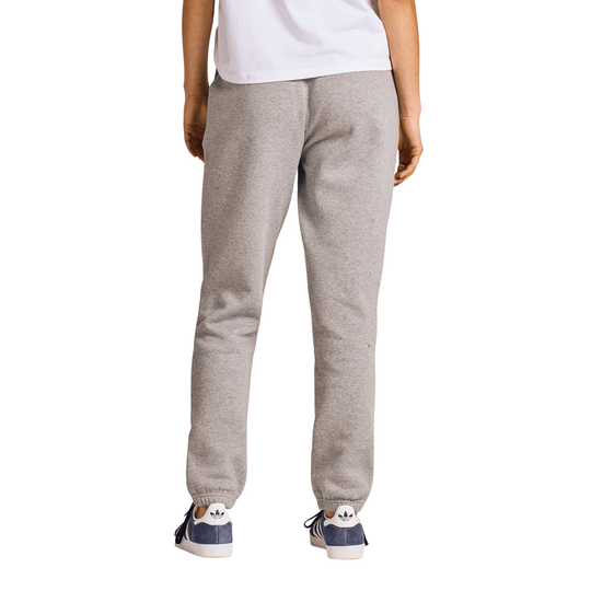 A person shown from the back wearing light heather gray sweatpants, a white t-shirt, and navy blue sneakers against a plain white background.