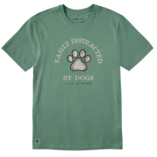 A sage green short-sleeve t-shirt with a graphic on the front featuring a dog paw print and the text 'EASILY DISTRACATED BY DOGS' and 'LIFE IS GOOD'.