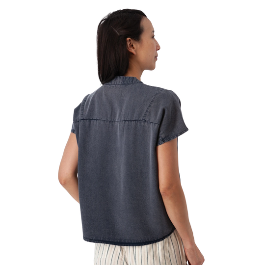 Woman wearing a blue sleeveless shirt on a white background