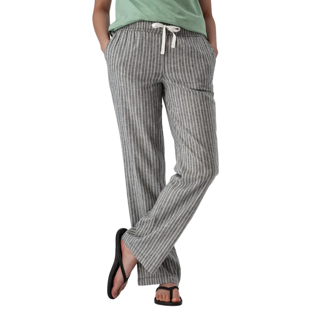 A person wearing gray and white vertically striped lounge pants with a white drawstring, paired with a light green top and black sandals, shown from the waist down on a white background.