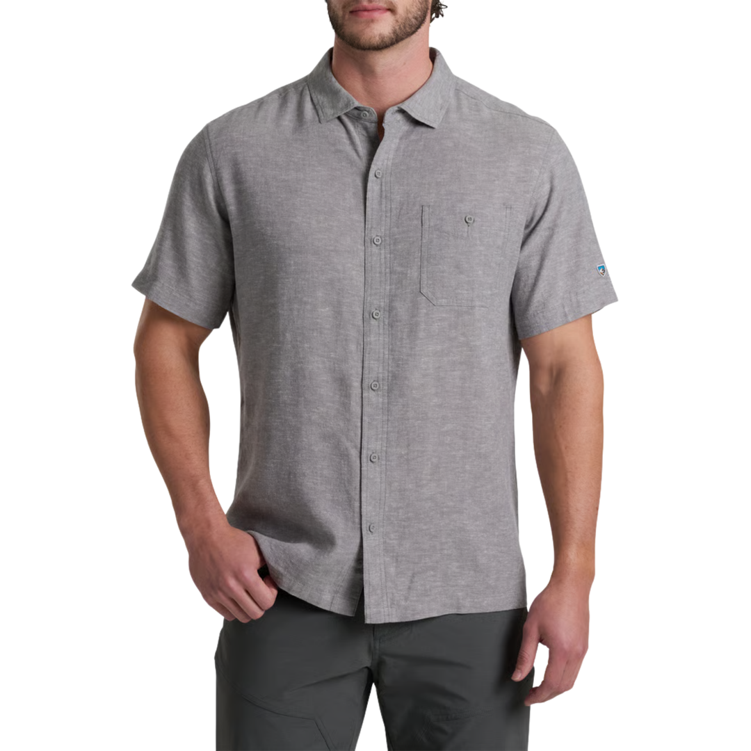 Man wearing a gray short-sleeve button-up shirt on a white background