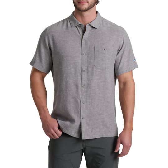 Man wearing a gray short-sleeve button-up shirt on a white background