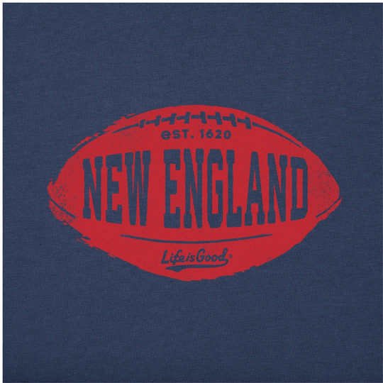 A close-up of a navy blue fabric surface featuring a large red football-shaped graphic with the words “NEW ENGLAND,” “EST. 1620,” and the Life is Good logo.