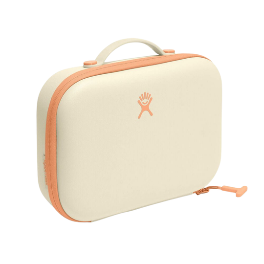 A cream-colored waterproof case with peach-orange trim, a top handle, and a small orange Hydro Flask logo on the front, set against a plain white background.