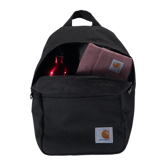 A black Carhartt backpack shown open against a white background, with a red bottle and a dusty rose Carhartt pouch visible inside.