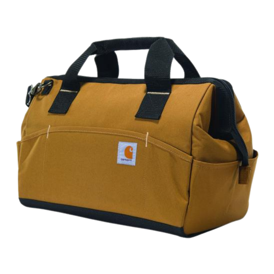 A Carhartt canvas tool bag in a mustard yellow color with black webbing handles, black trim, and a white Carhartt logo patch on the front pocket, set against a plain white background.