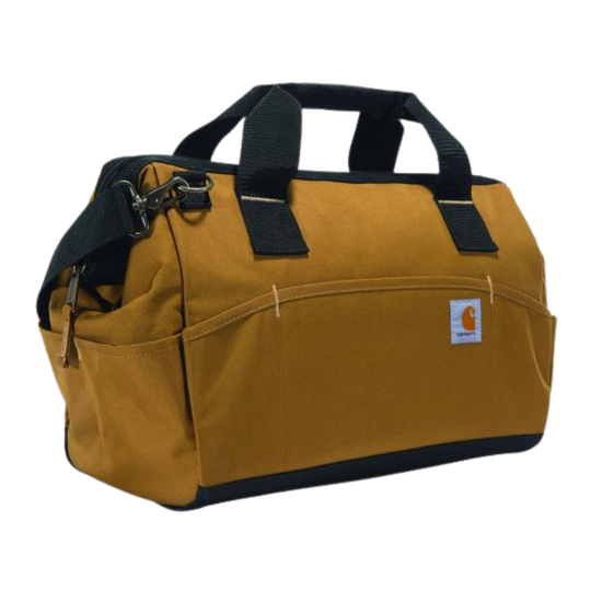 A Carhartt canvas duffel bag in a classic mustard yellow color with black webbing handles, a black bottom trim, and a black shoulder strap, shown on a plain white background.